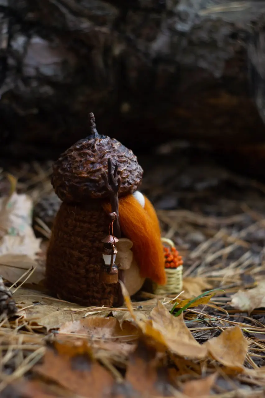 Handmade gnome in brown knitted vest with ginger beard