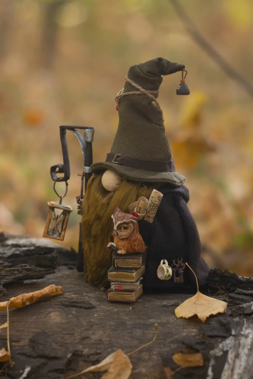 Owl Earl with archive key on a stack of books — closeup