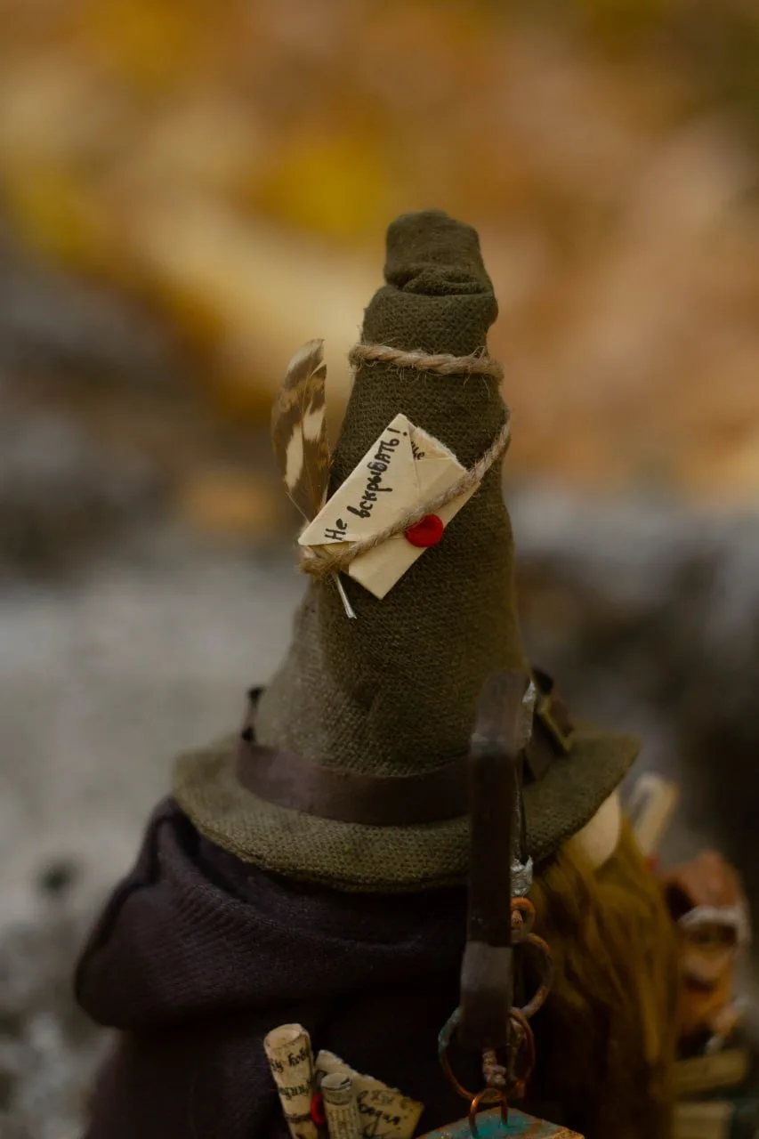 Gnome Archivist with lantern and owl Earl — side view on log