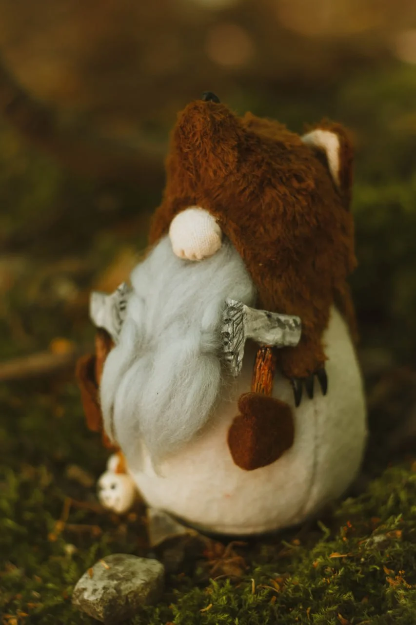 Gnome Berserker figure — full front view among autumn leaves and moss