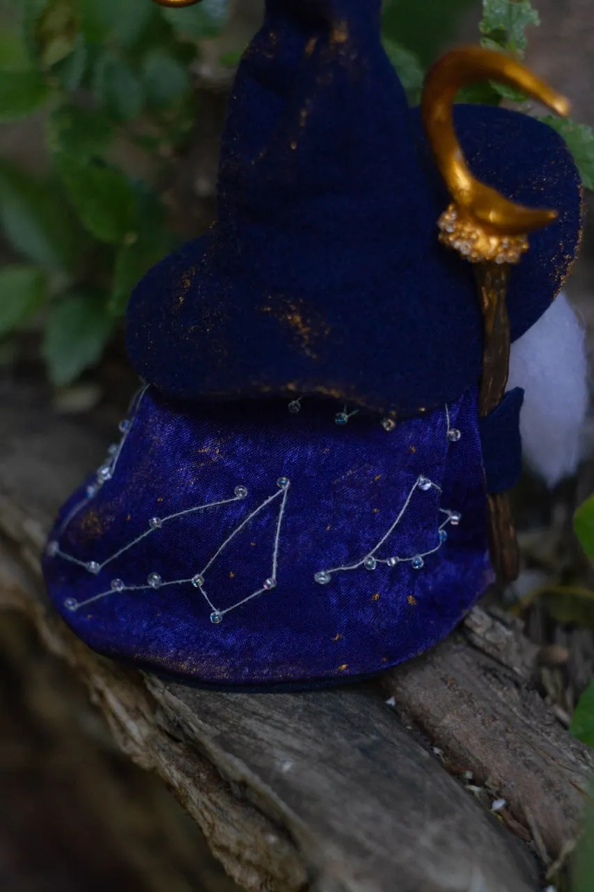 Decorative gnome in blue cosmic cloak with embroidered starry sky