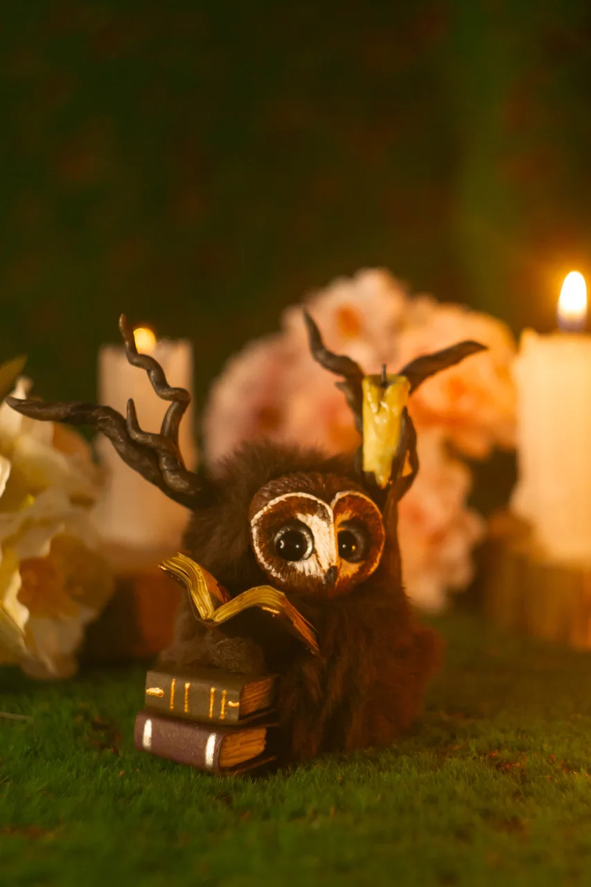 Rustle of Ancient Books fluffy — antler branches with books and glowing candle staff detail