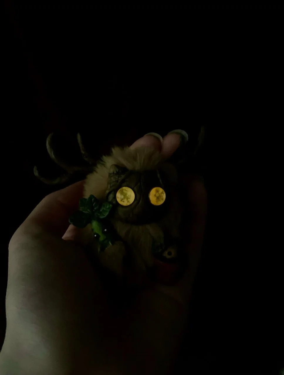 Botanist's Apprentice fluffy — yellow-green eyes glowing in the dark