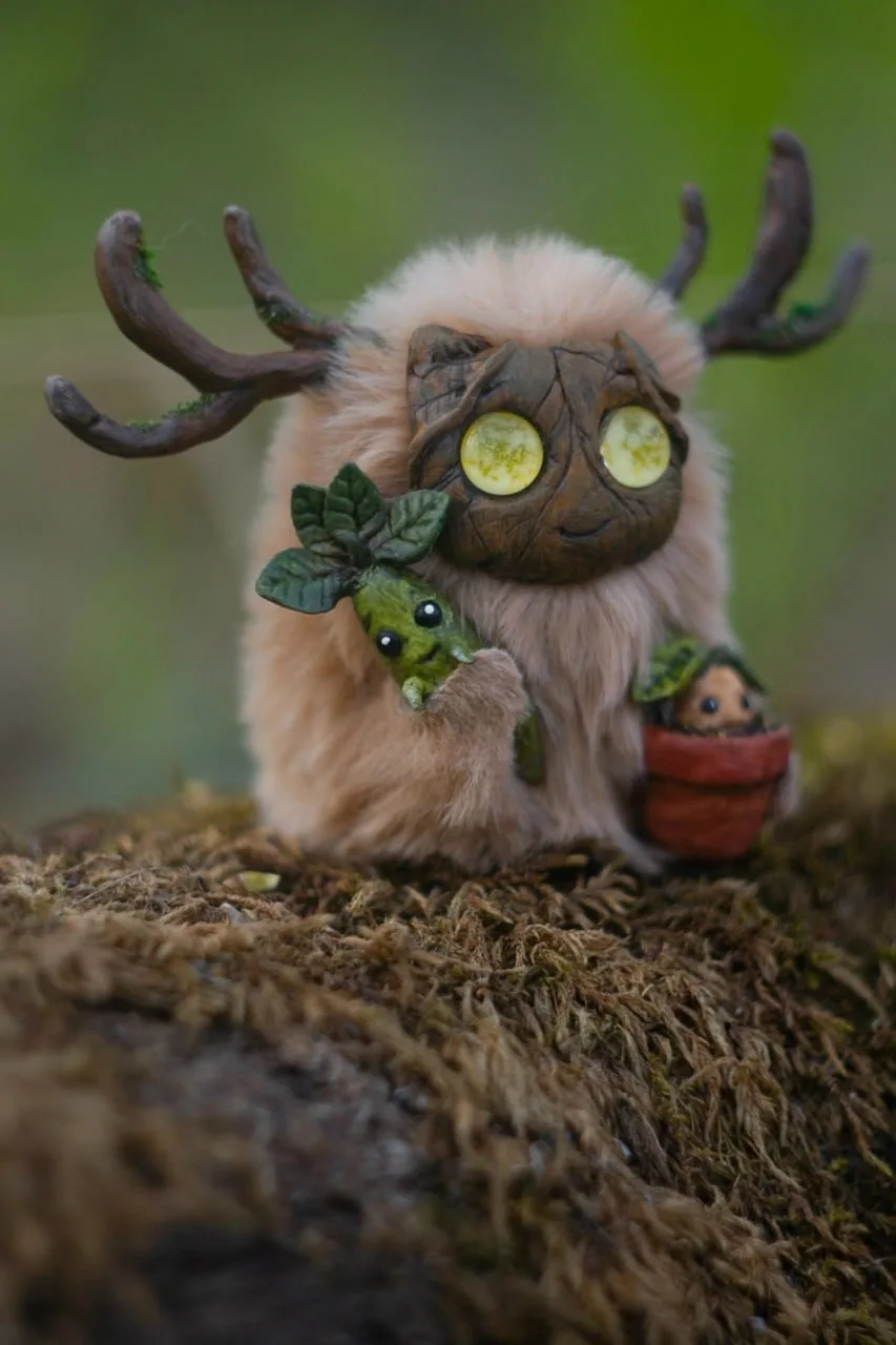 Botanist's Apprentice fluffy — holding a green leaf and Mandrake pot, front view