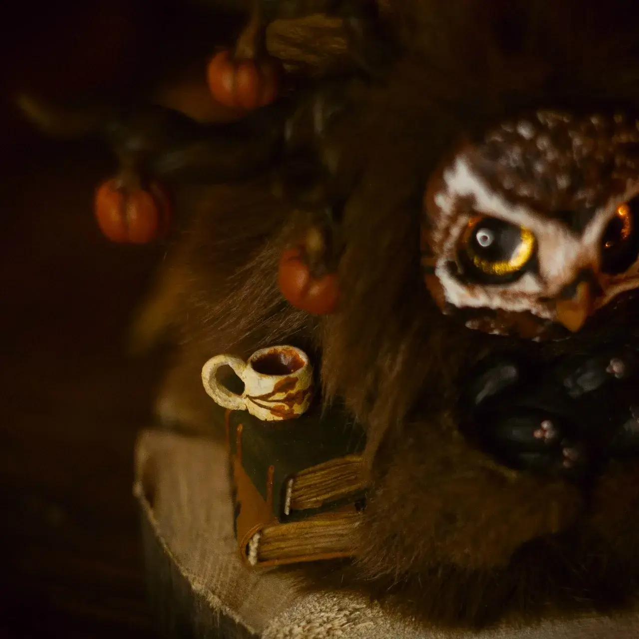 Dear Friend fluffy — detail of miniature ceramic mug with leaf pattern and stacked spell books