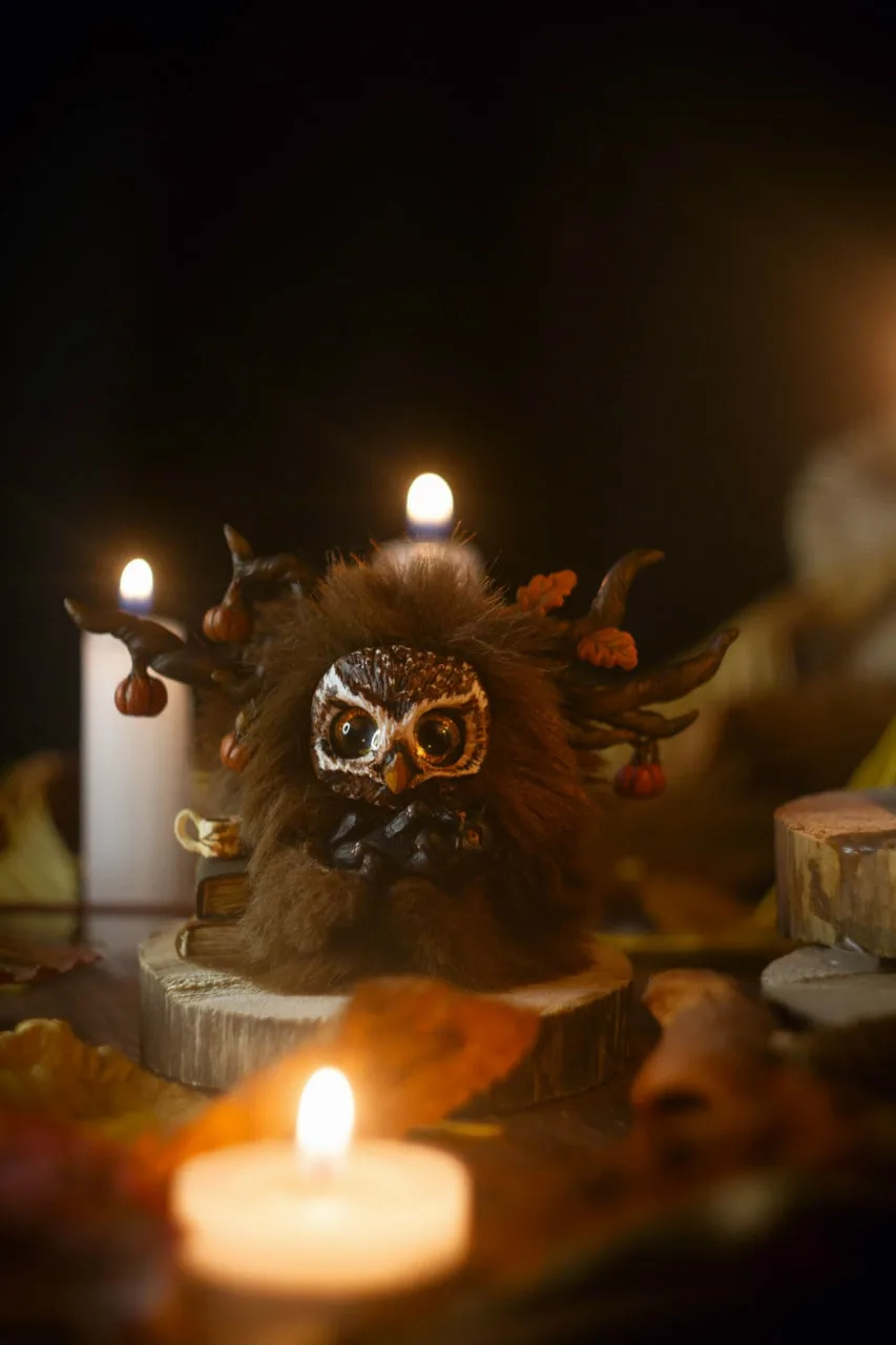 Dear Friend — handmade rich brown wool Fluffy owl-creature with pumpkin antlers, books and tea mug, surrounded by autumn candles | Gnomenlands
