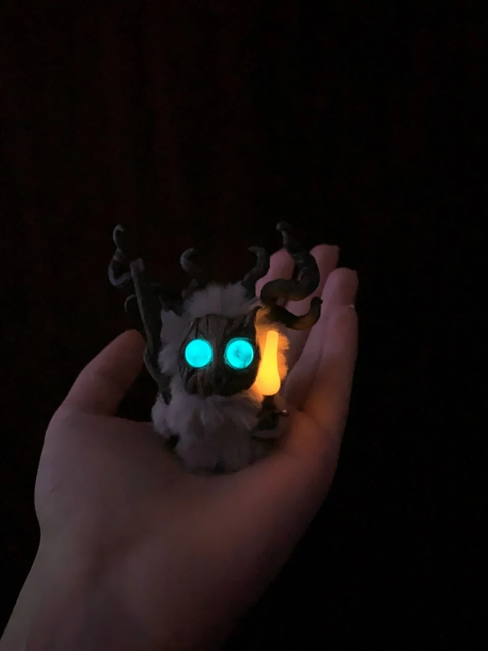 Echo of Fog fluffy — turquoise eyes glowing in darkness