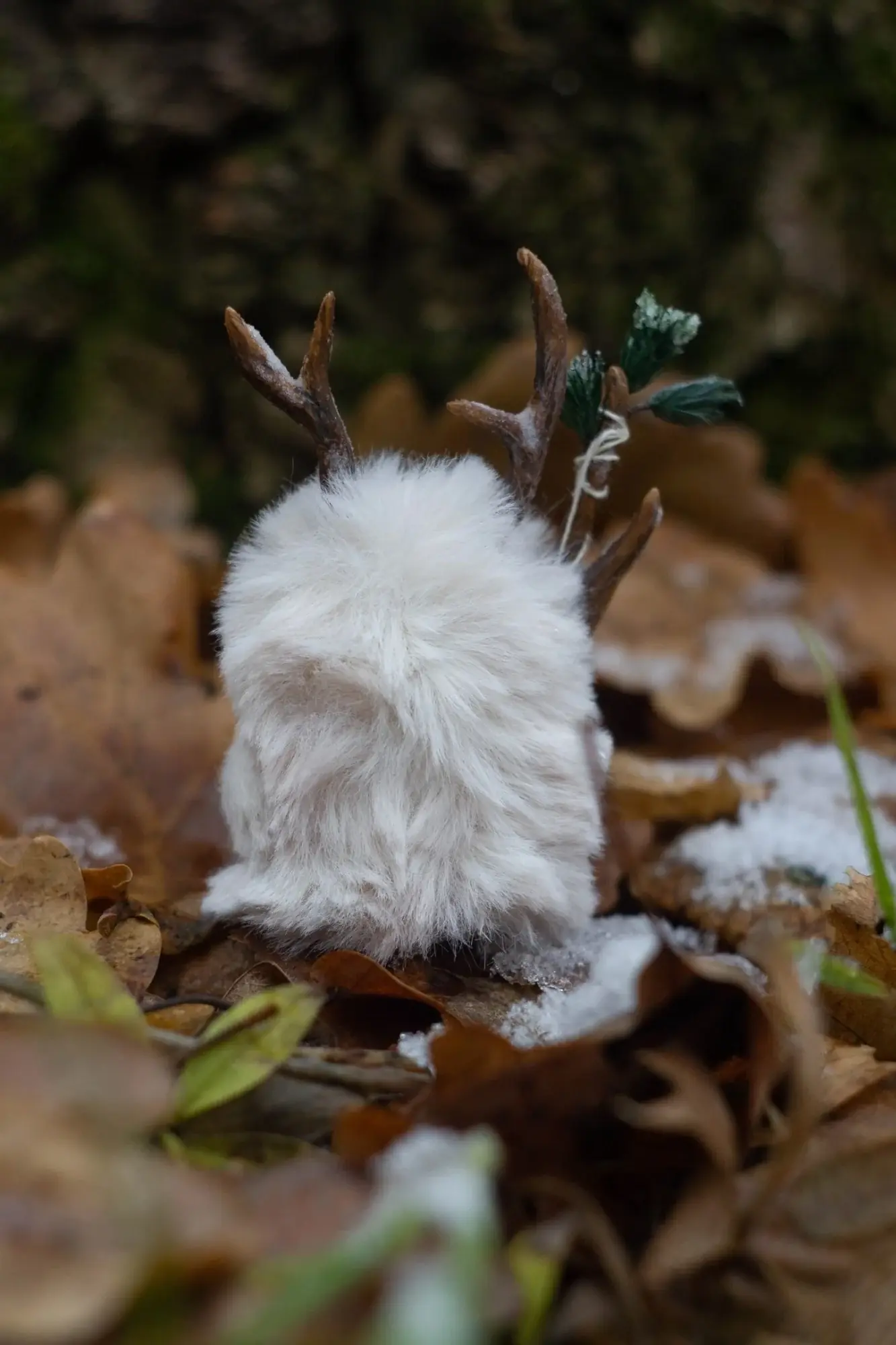First Snow fluffy — back view, pure white wool and brown antlers with fir