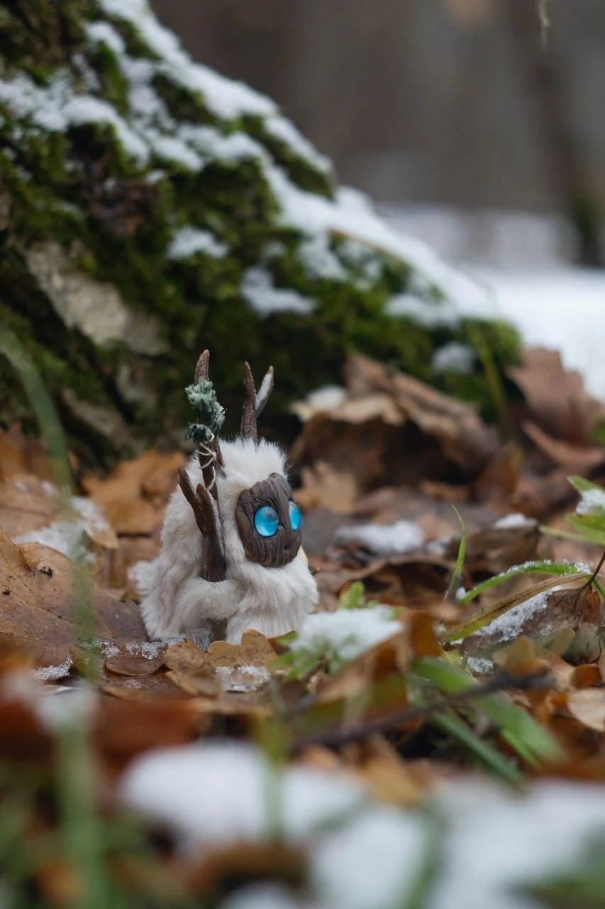 First Snow fluffy — side view near snowy moss with staff raised