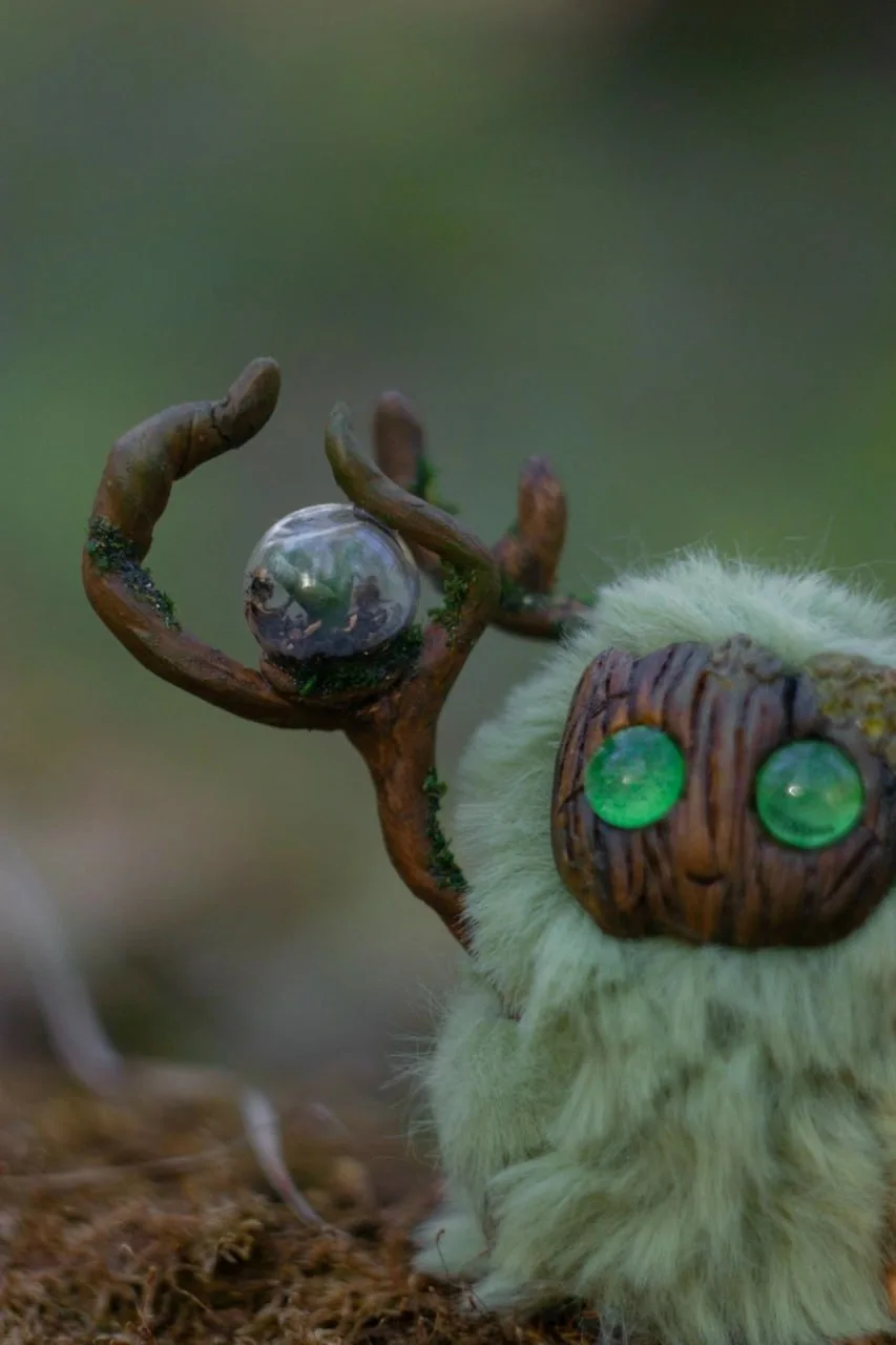 Greenhouse Keeper fluffy — close-up of staff with glass orb containing the first spring sprout