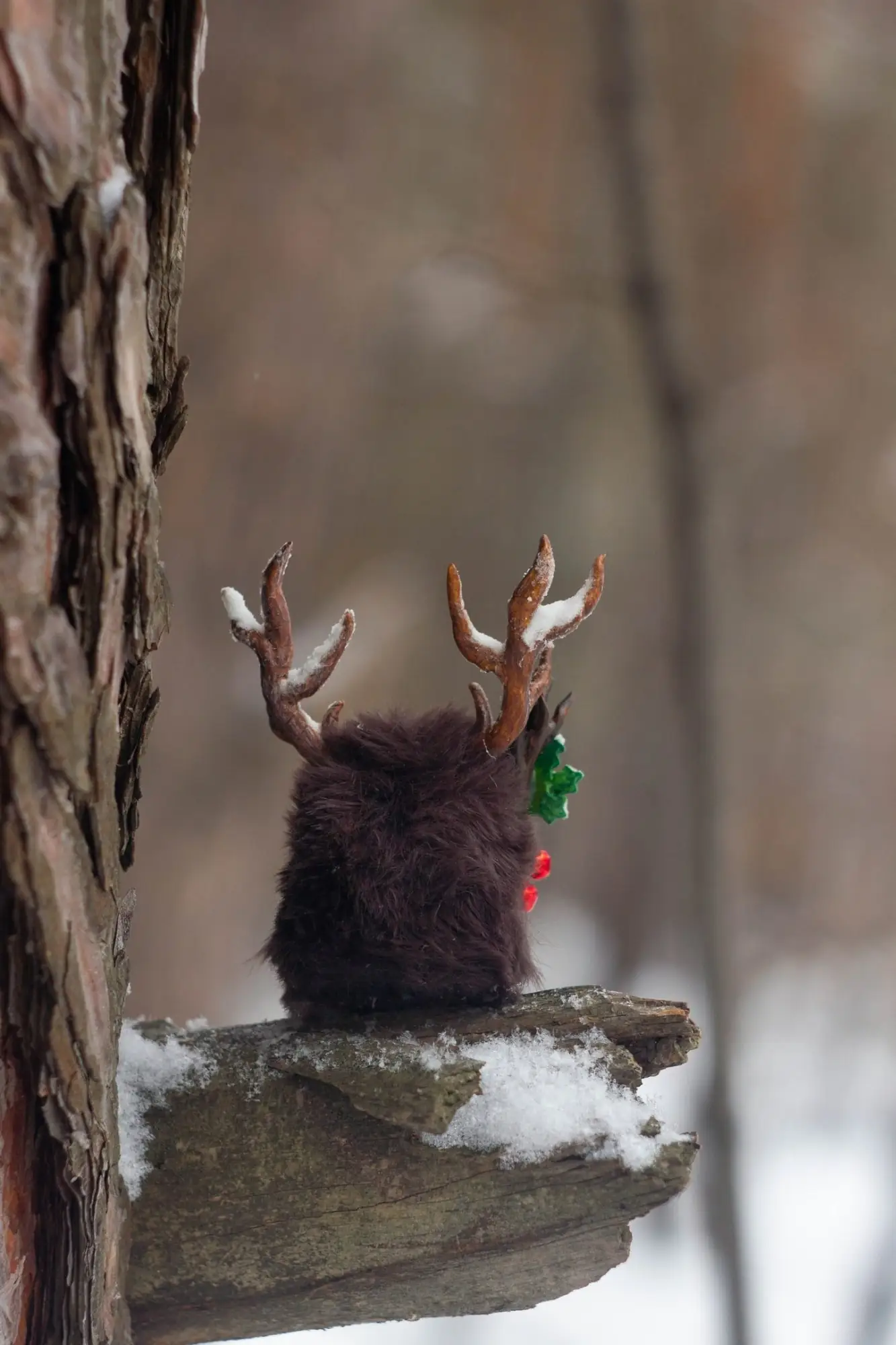Holly Spirit fluffy — back view with snow-white antler tips and holly with jingle bells visible from behind