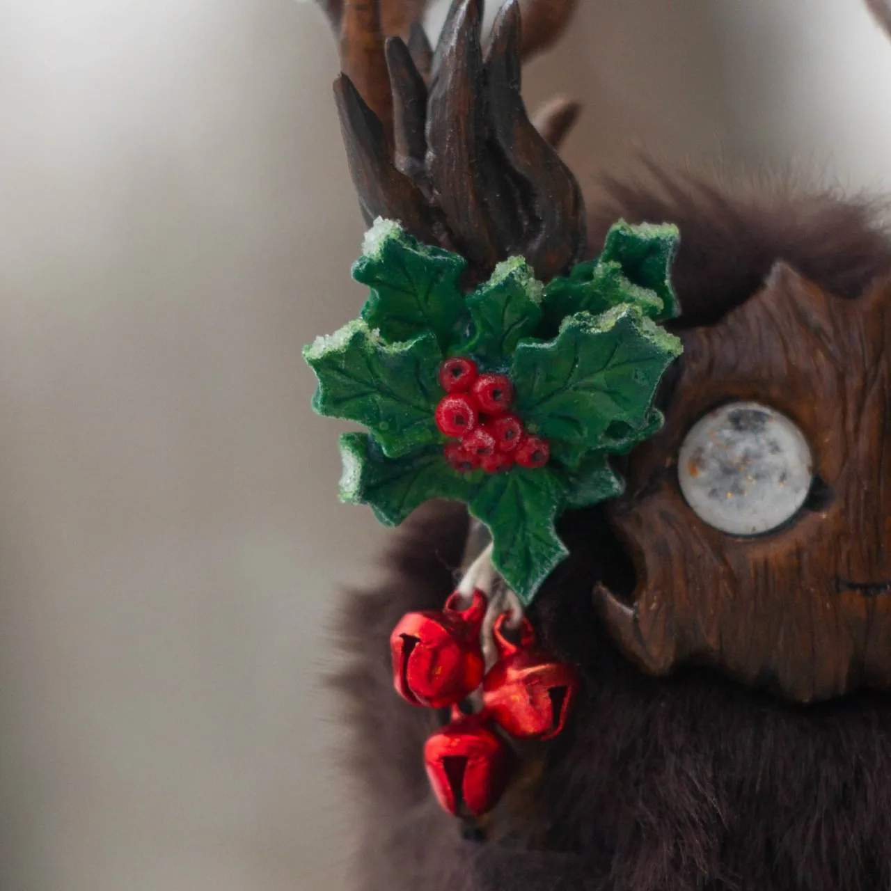 Holly Spirit fluffy — macro close-up of frosted holly leaves with red berries and three red jingle bells on antler