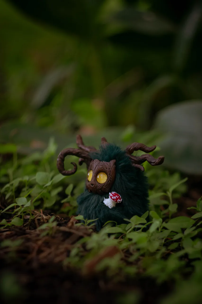 Mossy Flame fluffy — close-up portrait with soft warm-toned wool and curious expression