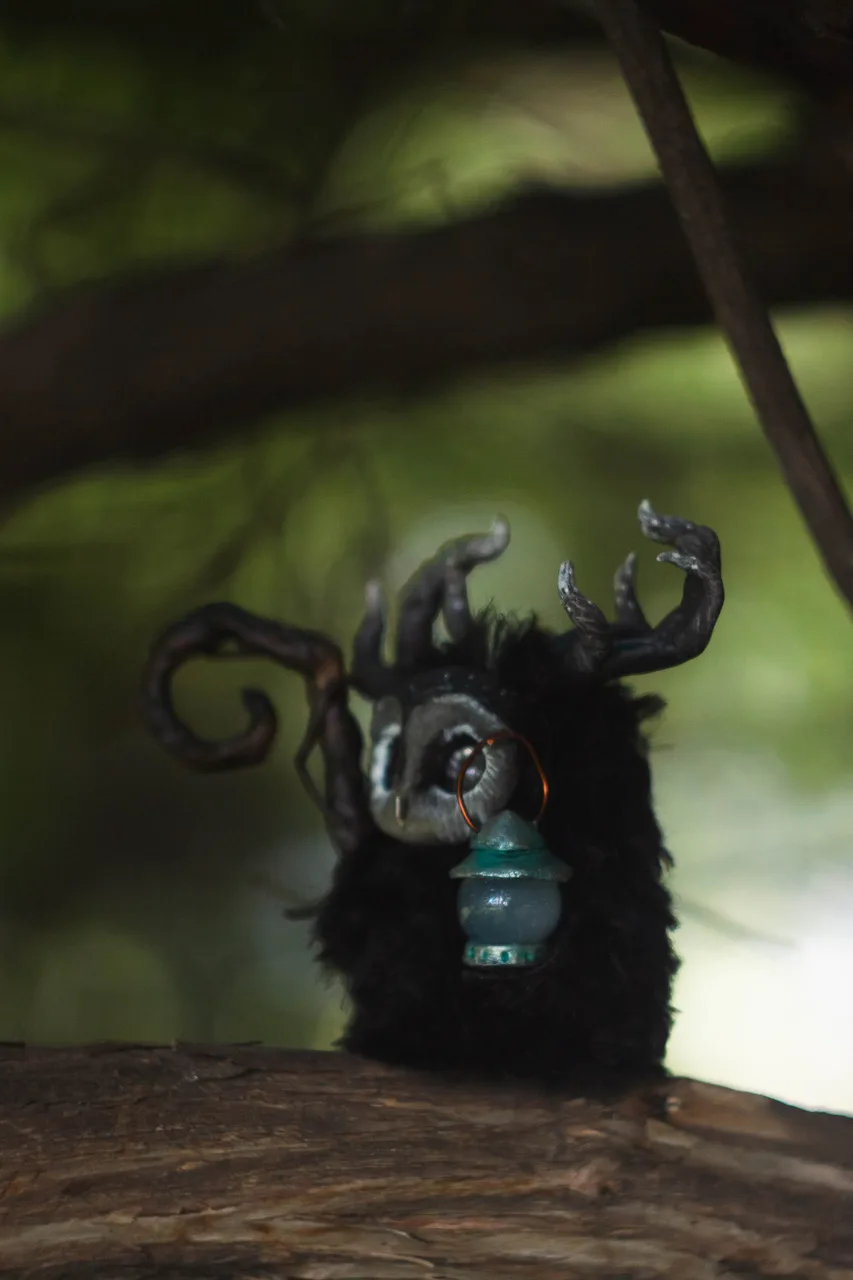 Night Wanderer fluffy — close-up of barn-owl mask with silver-glowing eyes in the dark