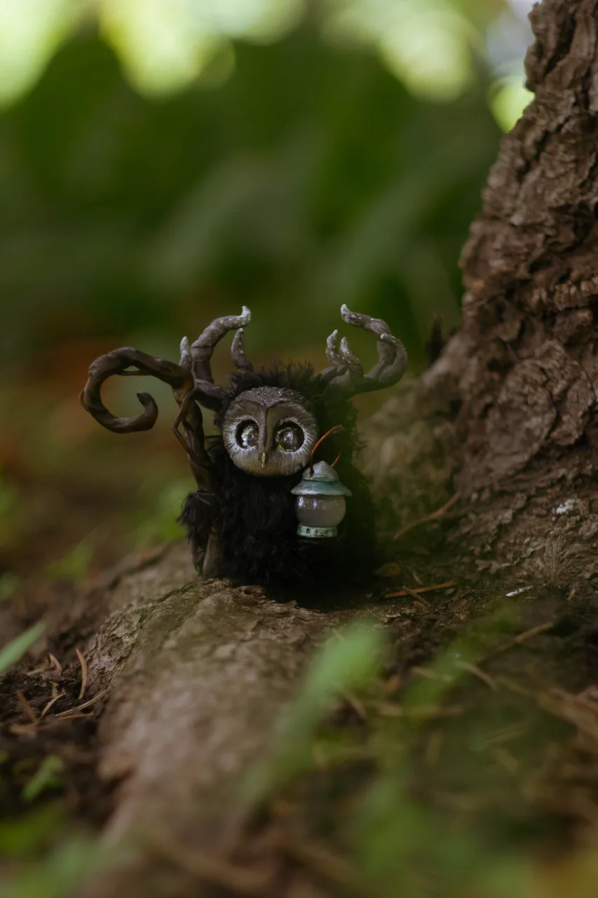 Night Wanderer — handmade black wool Fluffy in a barn-owl mask with tin lantern, blending into the dark night forest | Gnomenlands