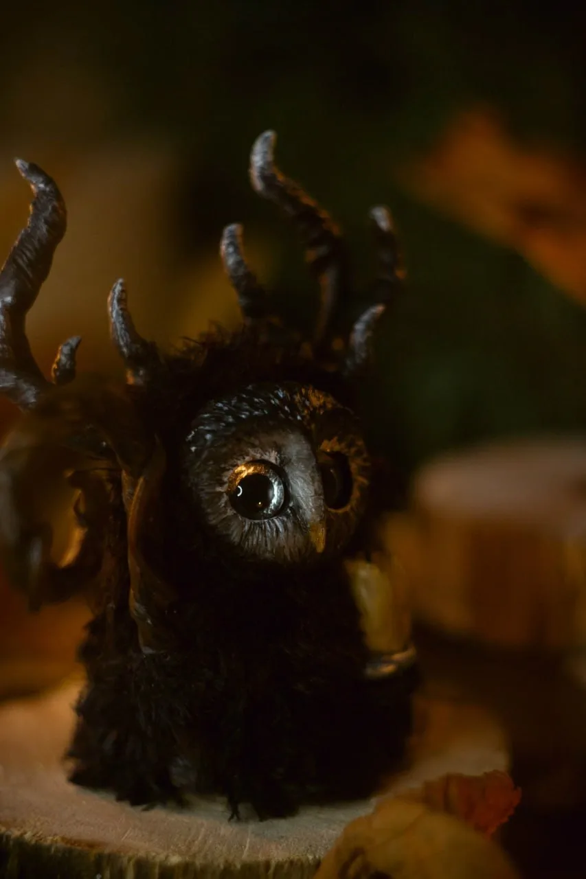 Night Wanderer fluffy — dark moody portrait, single eye glowing amber in the darkness