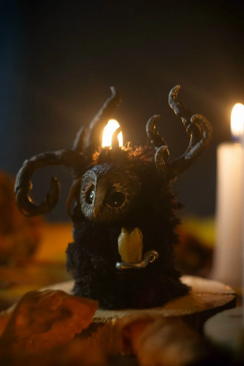 Night Wanderer fluffy — holding a glowing candle lantern, dark antlers lit from below