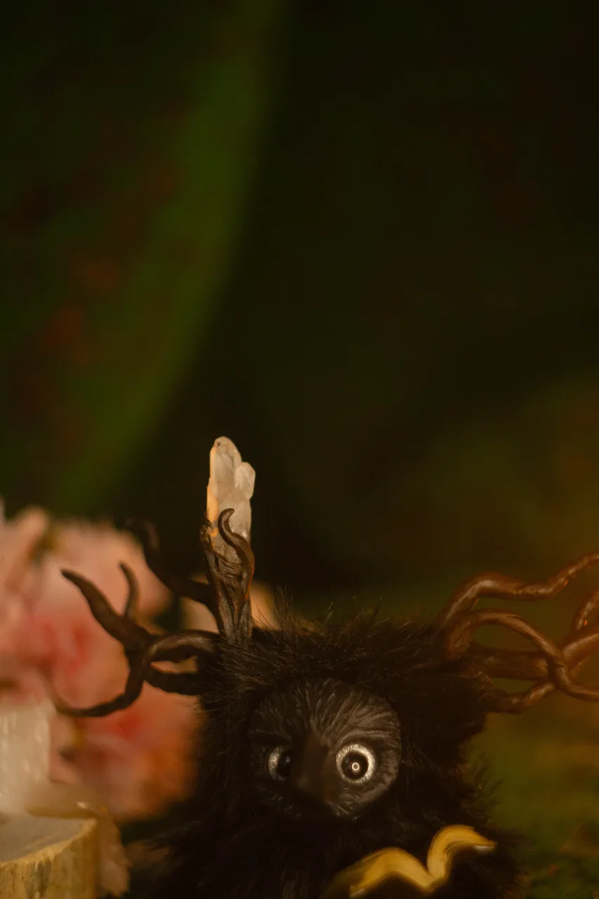 Omniscient Raven fluffy — close-up of open book that never closes and antler branch detail