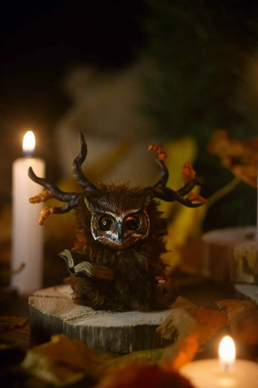 Rustle of Leaf Fall — handmade brown wool Fluffy owl-creature with autumn leaf antlers and open spell book by candlelight | Gnomenlands