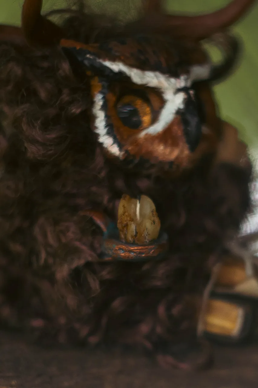 Wise Owl fluffy — detail of copper candlestick and open book held in paws