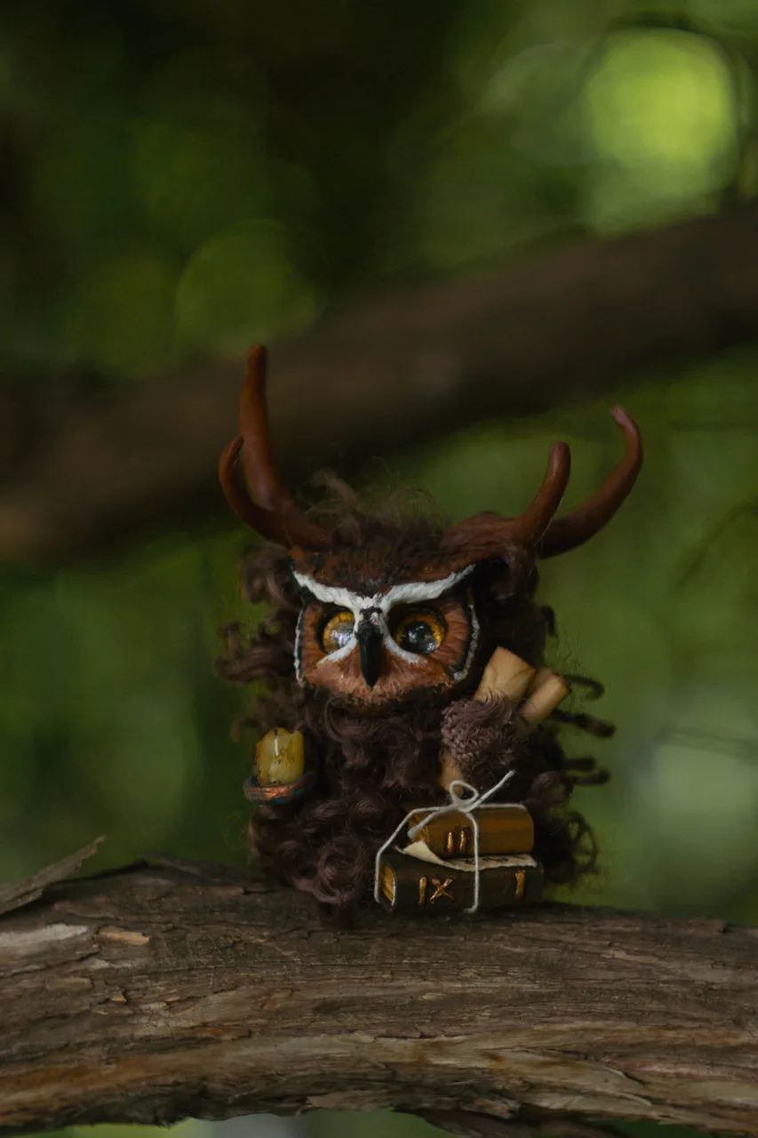 Wise Owl Fluffy — handmade wool forest spirit with copper candlestick and open book, reading in the hollow of an ancient oak at twilight