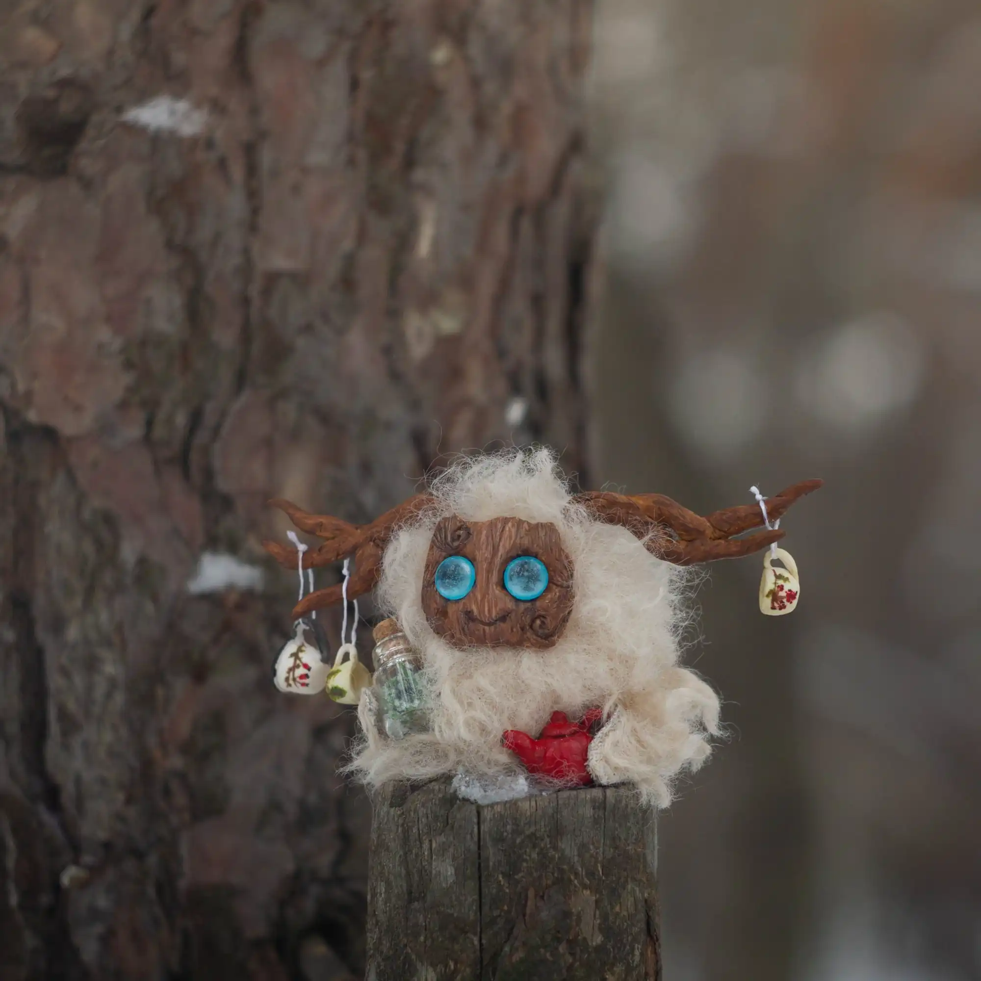 Yeti — handmade long-haired white wool Fluffy creature with brown antlers, blue glowing eyes, holding a tiny potion bottle and decorated teacups | Gnomenlands