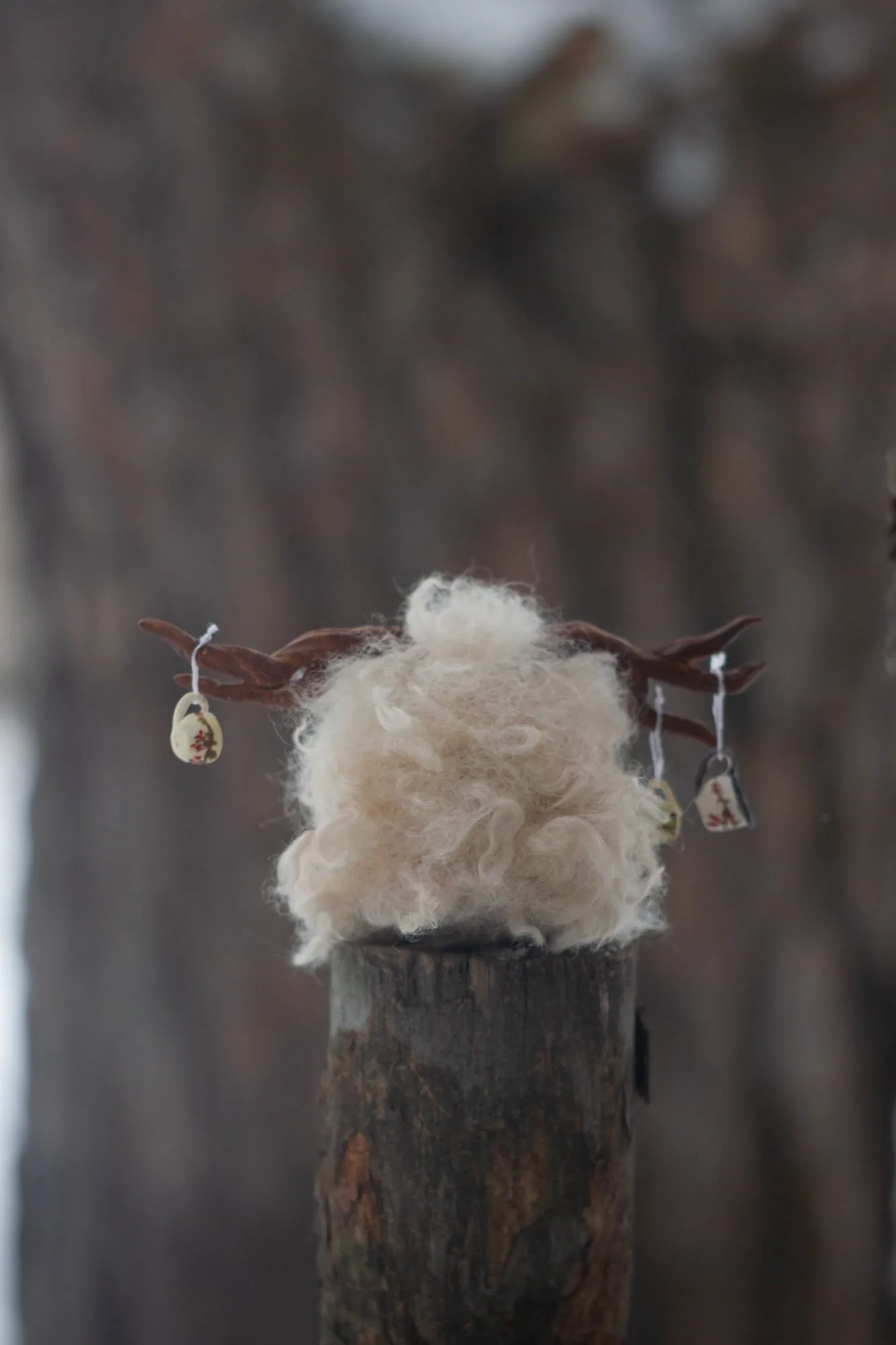 Yeti fluffy — side view on a stump, long white wool and antlers