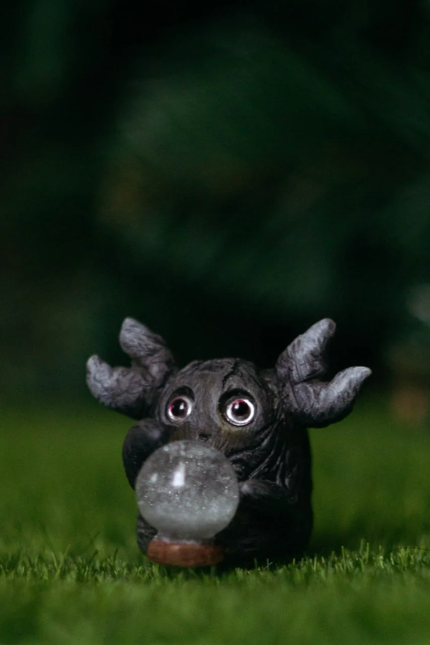 Forest Sprite Oracle — photographed in dim light, pink eyes glowing