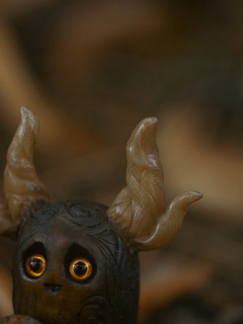 Forest Sprite Pumpkin Keeper — extreme closeup of amber branching horns and carved head texture