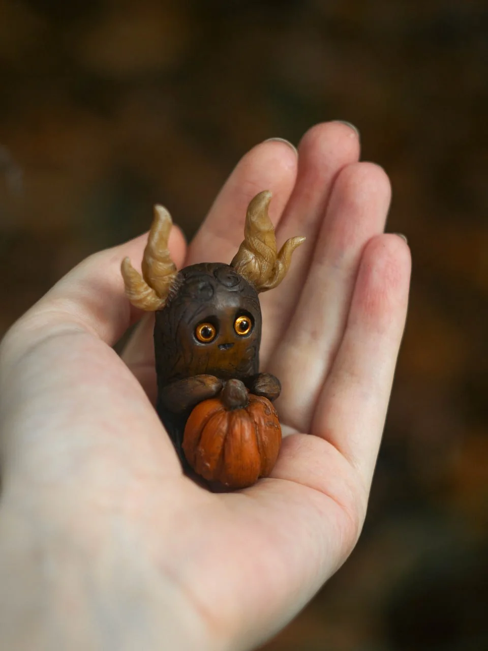 Forest Sprite Pumpkin Keeper with pumpkin held in hand — scale reference for collectors