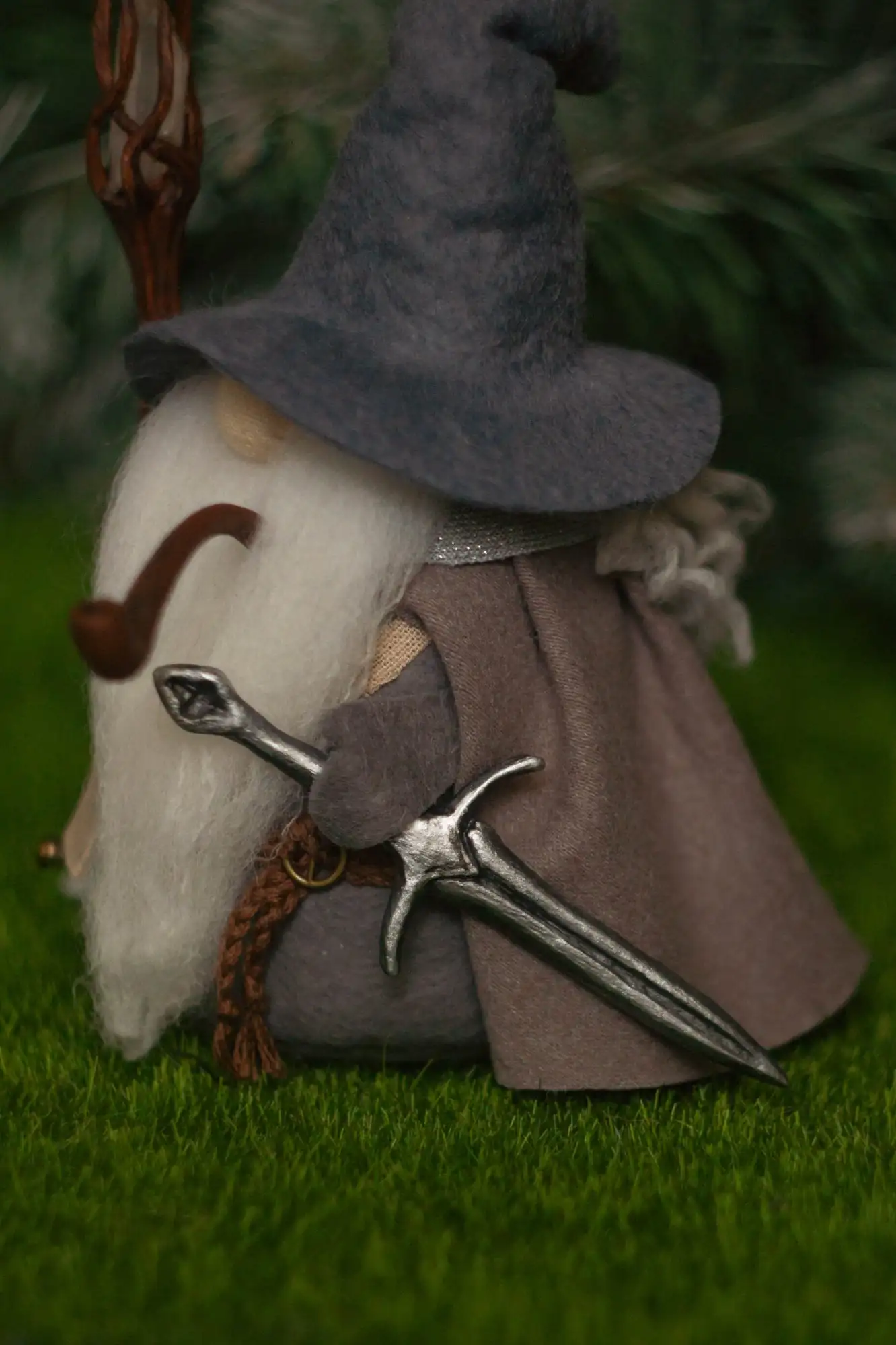 Gandalf gnome with Glamdring sword — side view, silvery blade and grey cloak