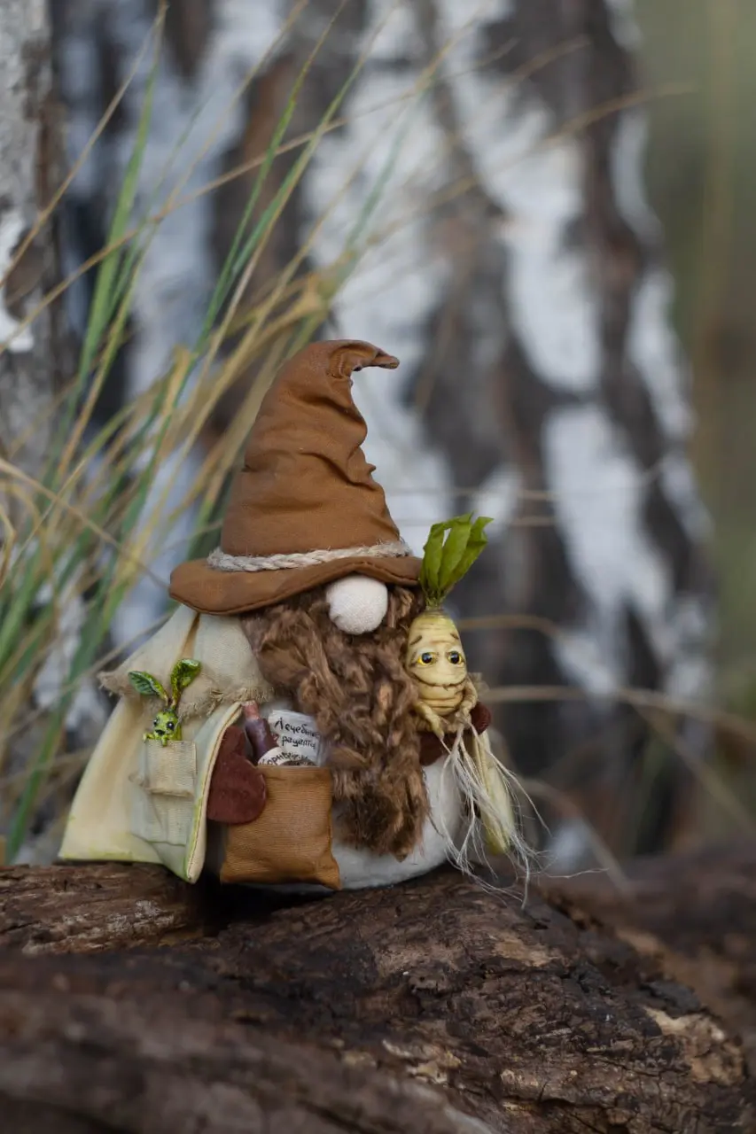 Handmade herbalist gnome with brown beard and magical plant