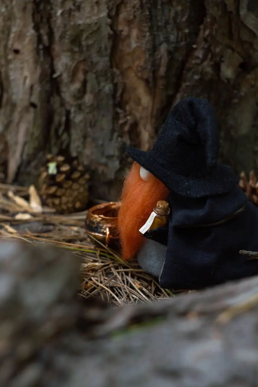 Interior magical red-bearded sorcerer gnome with potions