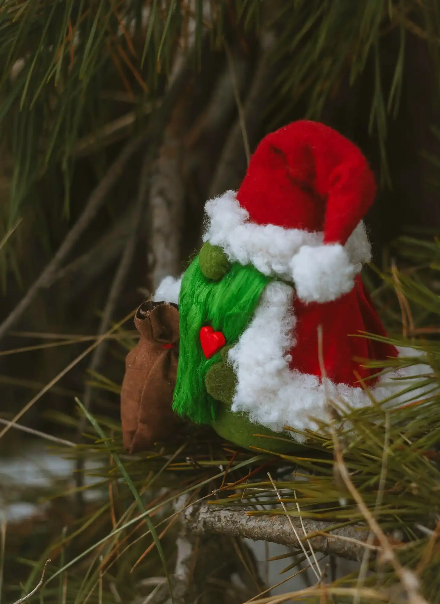 Gift Gnome Grinch — side view in branches, heart and suede bag