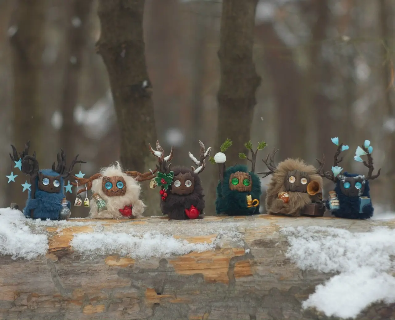 Handmade Fluffy forest creatures from the 'Winter's Call' collection — six wool creatures on a snowy log | Gnomenlands