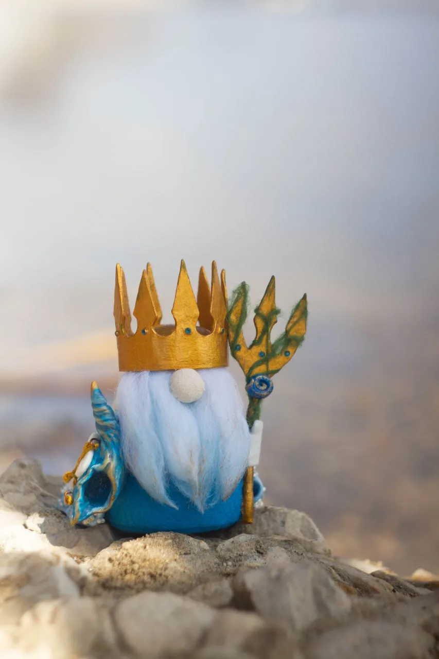 Gnome Poseidon with golden trident — front view by water