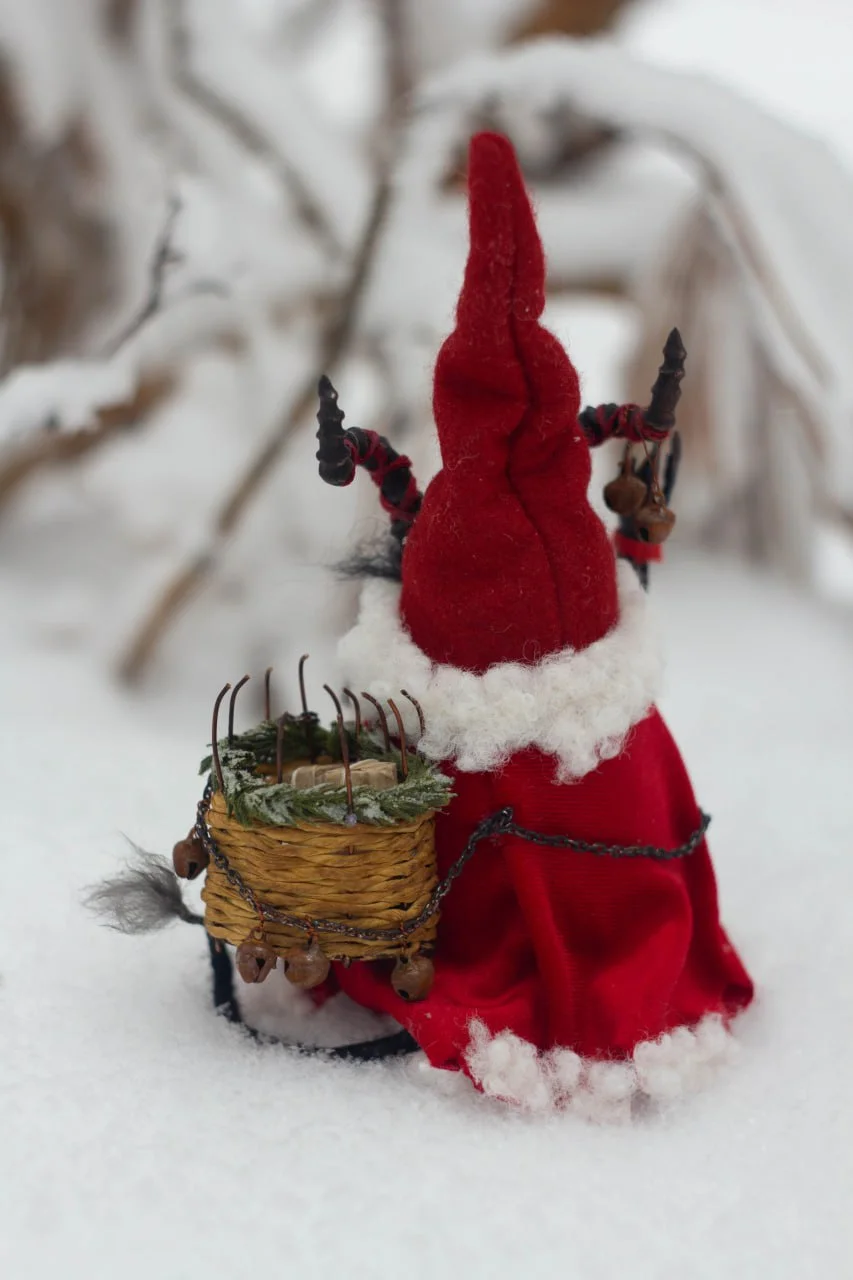 Gnome Krampus decor — rear view in velvet cloak on snow