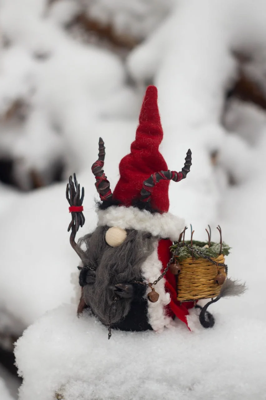 Christmas Gnome Krampus — full view among snowy rocks