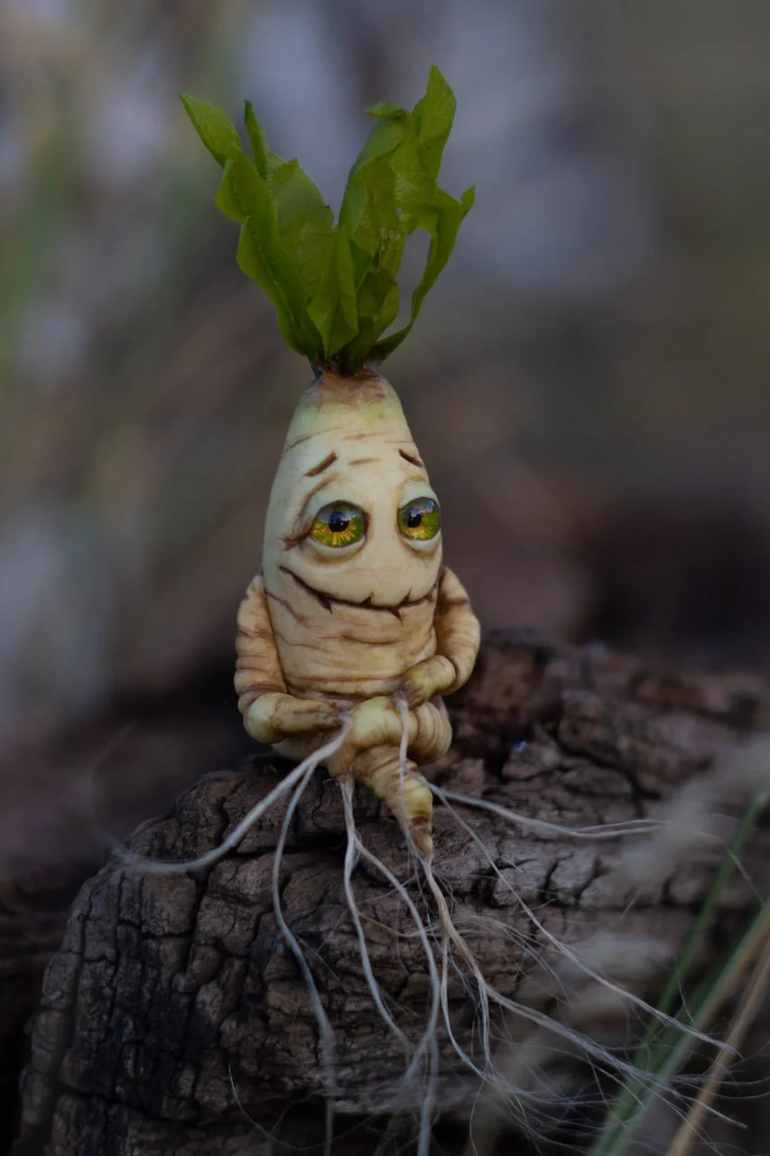 Classic mandrake figurine closeup — detailed polymer clay texture and golden glass following eyes