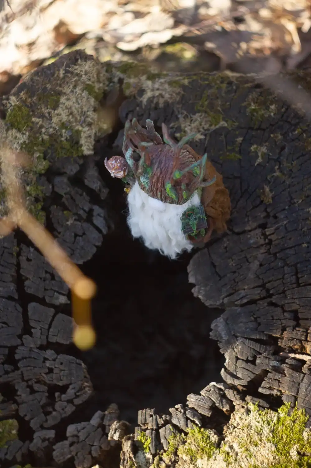 Scandinavian Gnome Night Warden — on logs in twilight forest with sunset bokeh