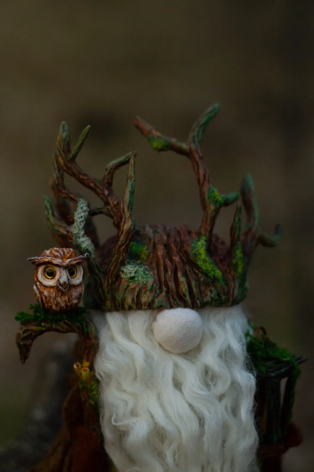 Gnome Night Warden — branch and lichen helmet with follow-eyed clay owl — closeup