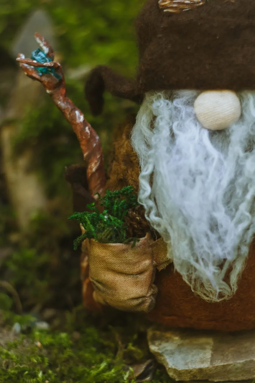 Gnome's moss satchel and crystal staff — accessory closeup