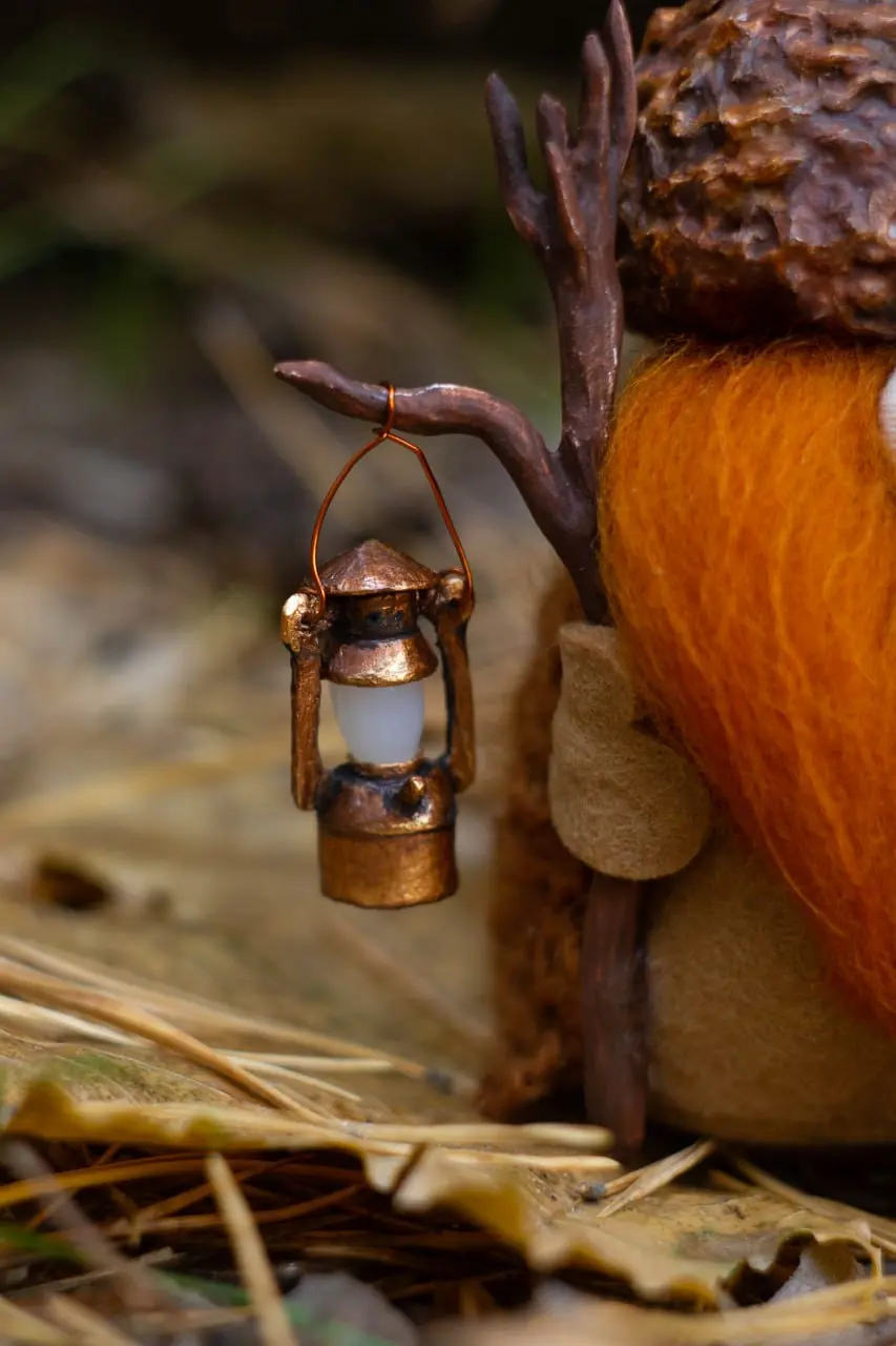 Magical Scandinavian gnome with oil lamp on his staff