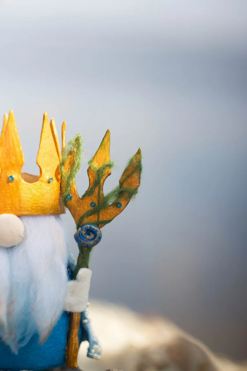 Sea King gnome's golden trident with seaweed — closeup