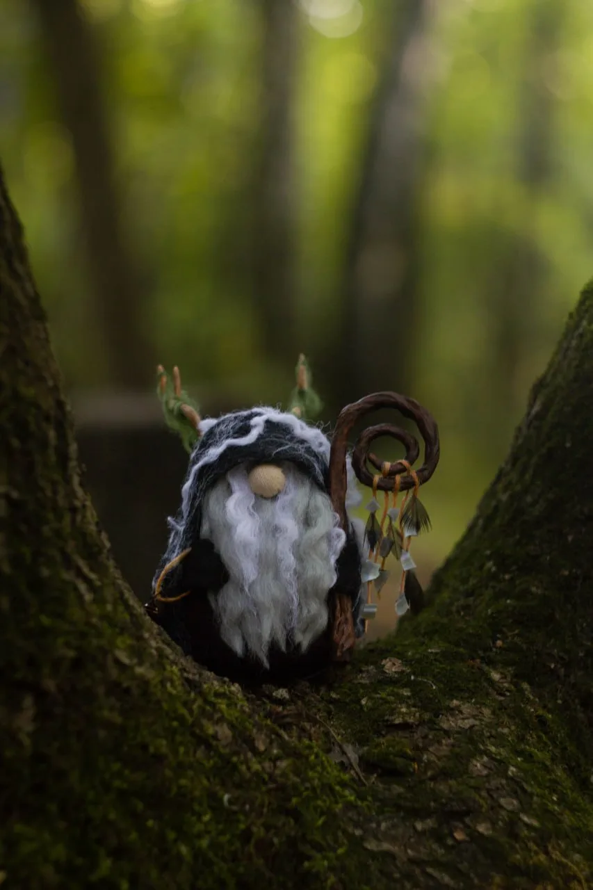 Shaman gnome on mossy tree in forest — mystical handmade photo