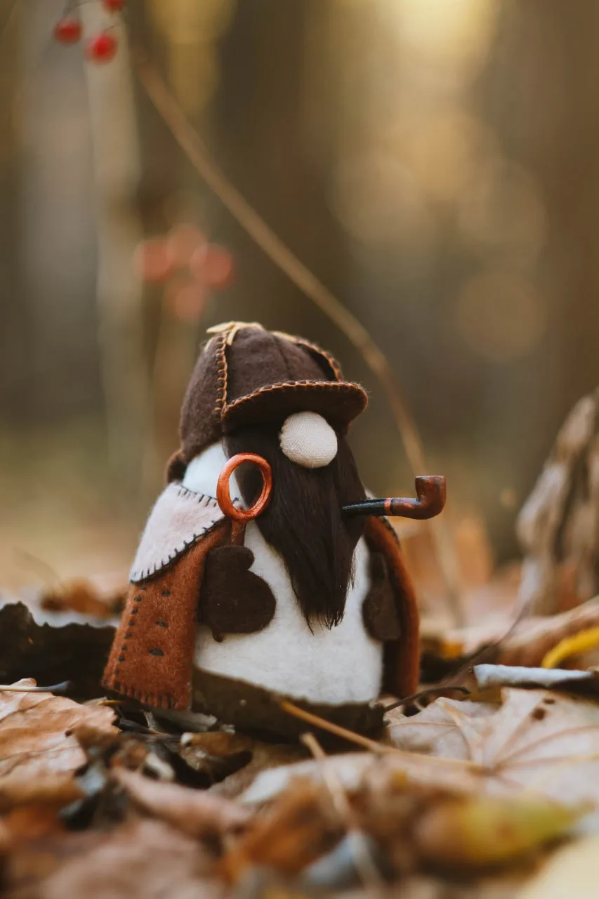 Detective Gnome Sherlock Holmes — front view among autumn leaves