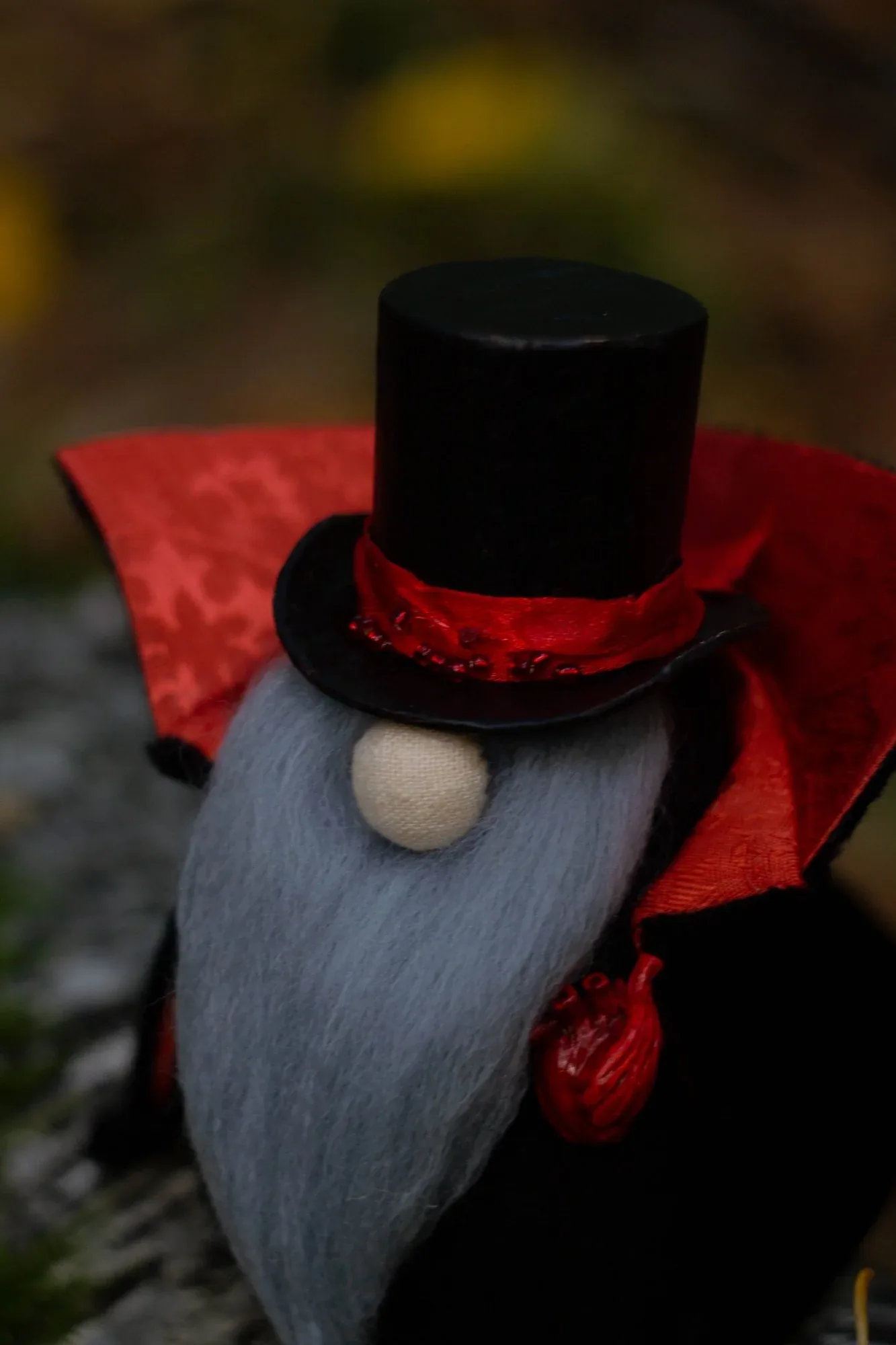 Scandinavian Gnome Vampire — top hat and clay hearts by candlelight on wooden table