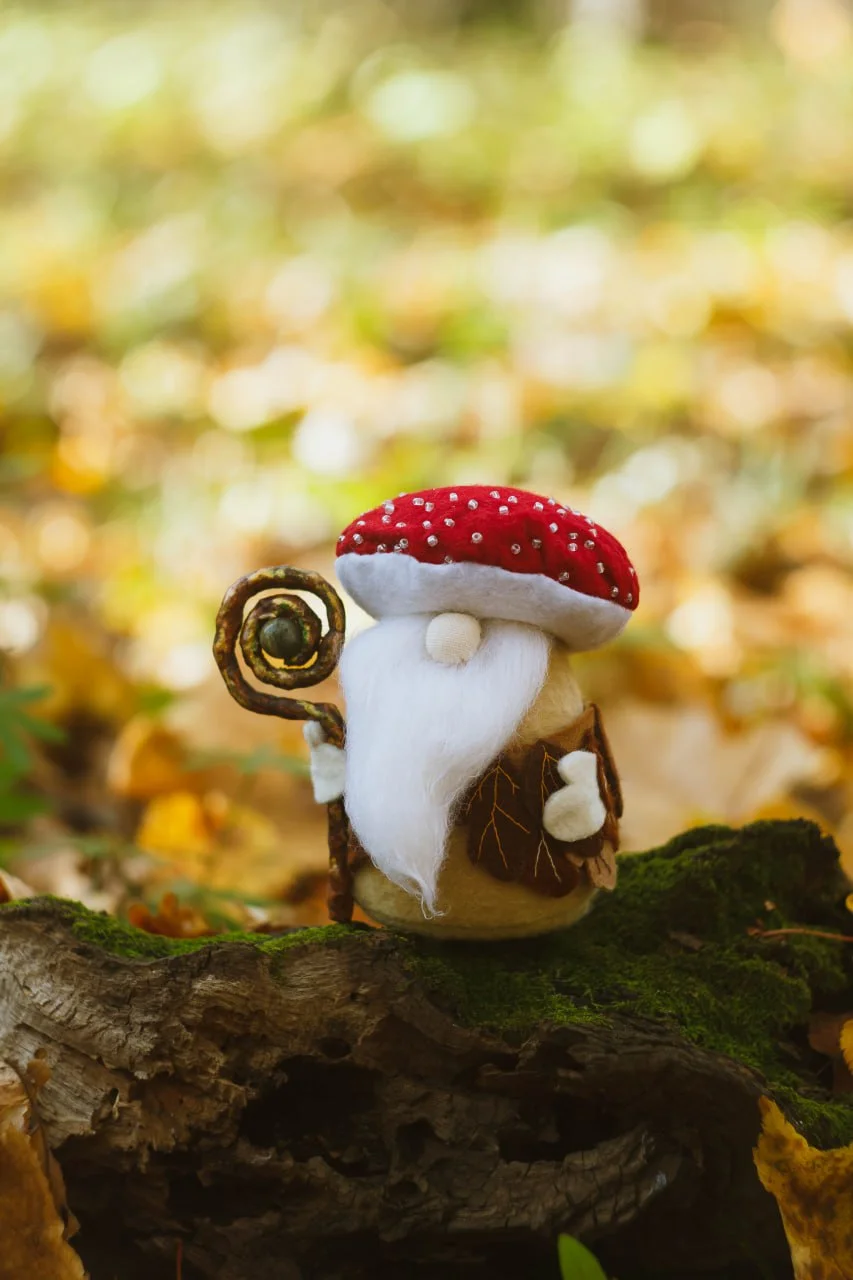 Collectible Scandinavian fly-agaric gnome on a log