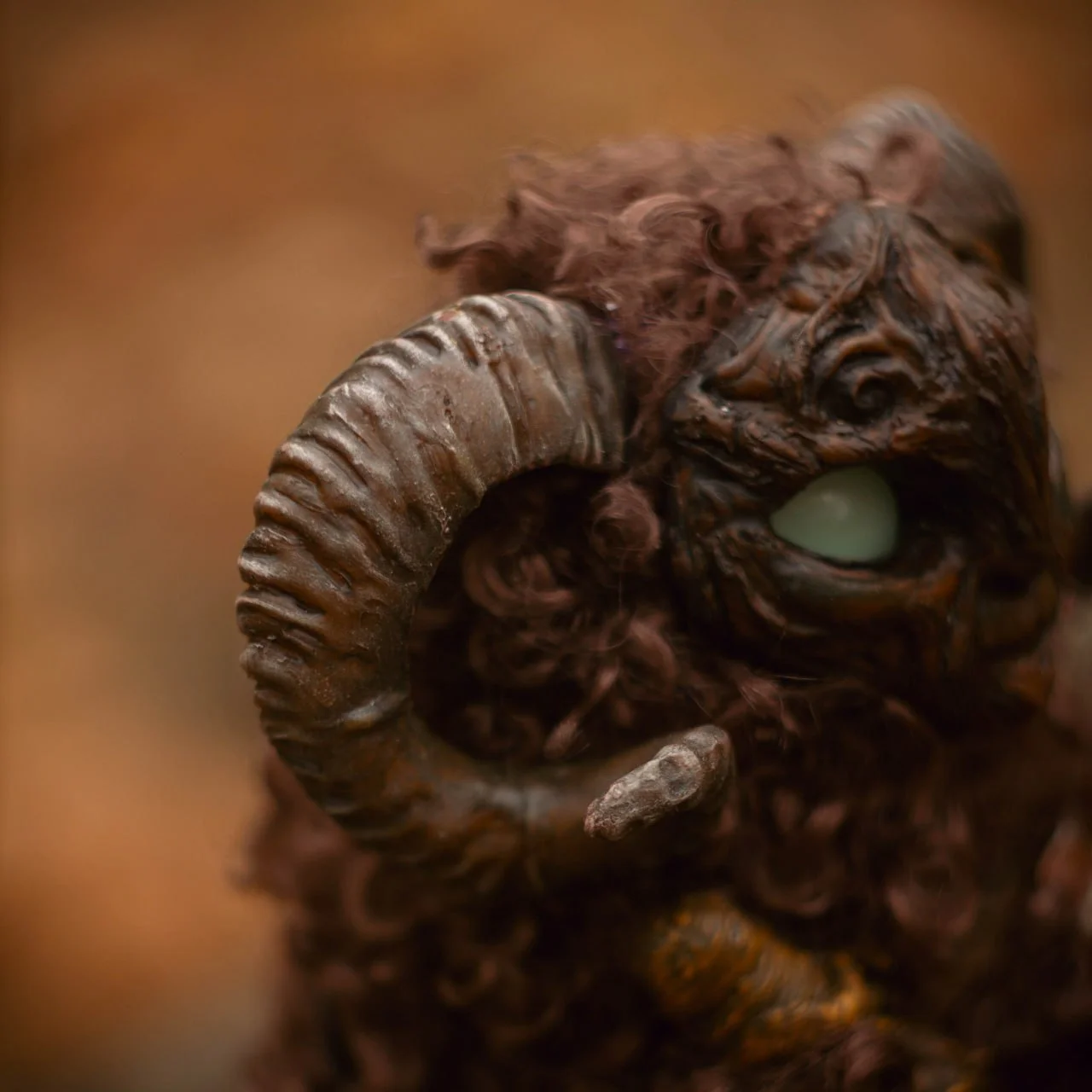 Wood Spirit Faun — profile with coiled ram horns and glowing blue eye, handmade polymer clay collectible figurine inspired by Pan's Labyrinth, artisan fantasy home décor