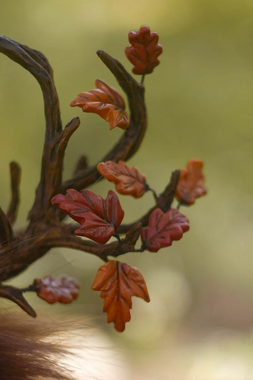 Wooden lantern of Wood Spirit Mabon Rustle close-up — handcrafted polymer clay with bark texture and rowan cluster above, artisan collectible figurine accessory